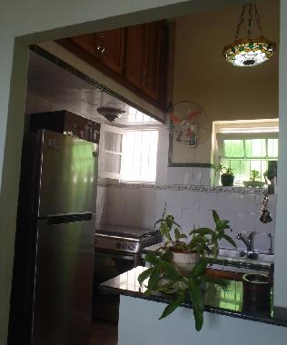Kitchen has microwave, gas stove with oven and a two doors refrigerator.