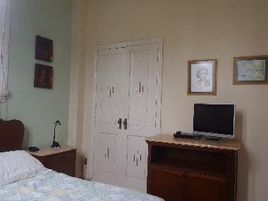 Master bedroom has a closet with hangers and a safe box.