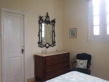 Master bedroom has a chest of drawers with a mirror.